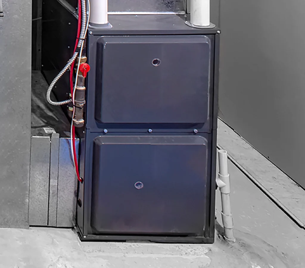 Common causes of a furnace leaking water include problems with the condensate drain line shown on this high-efficiency furnace.