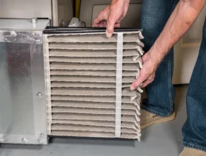Rocket Air - Furnace Blowing Cold Air - Technician replacing a dirty furnace filter to restore airflow
